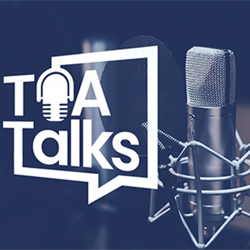 A studio microphone and pop filter next to a "TFA Talks" podcast logo with a speech bubble and mic icon.