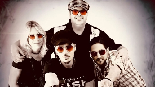 Members of the band Fiddlestix huddle together.