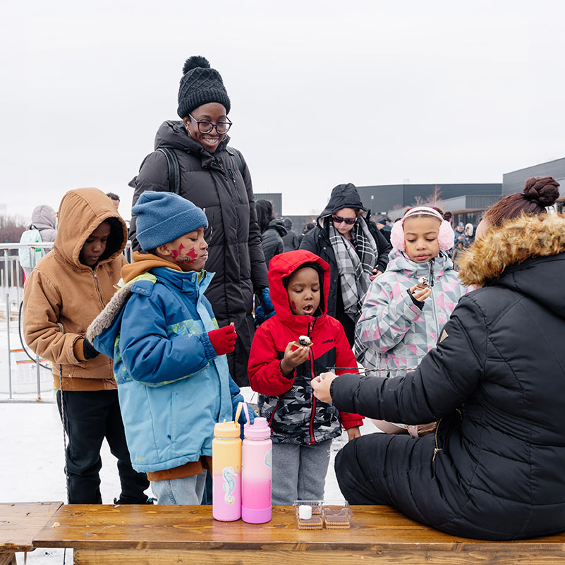 People gather around the s'mores making station at Winterfest.