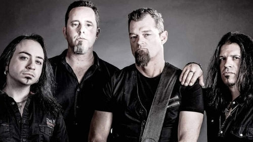 Members of the band Sandman stand together all dressed in black.