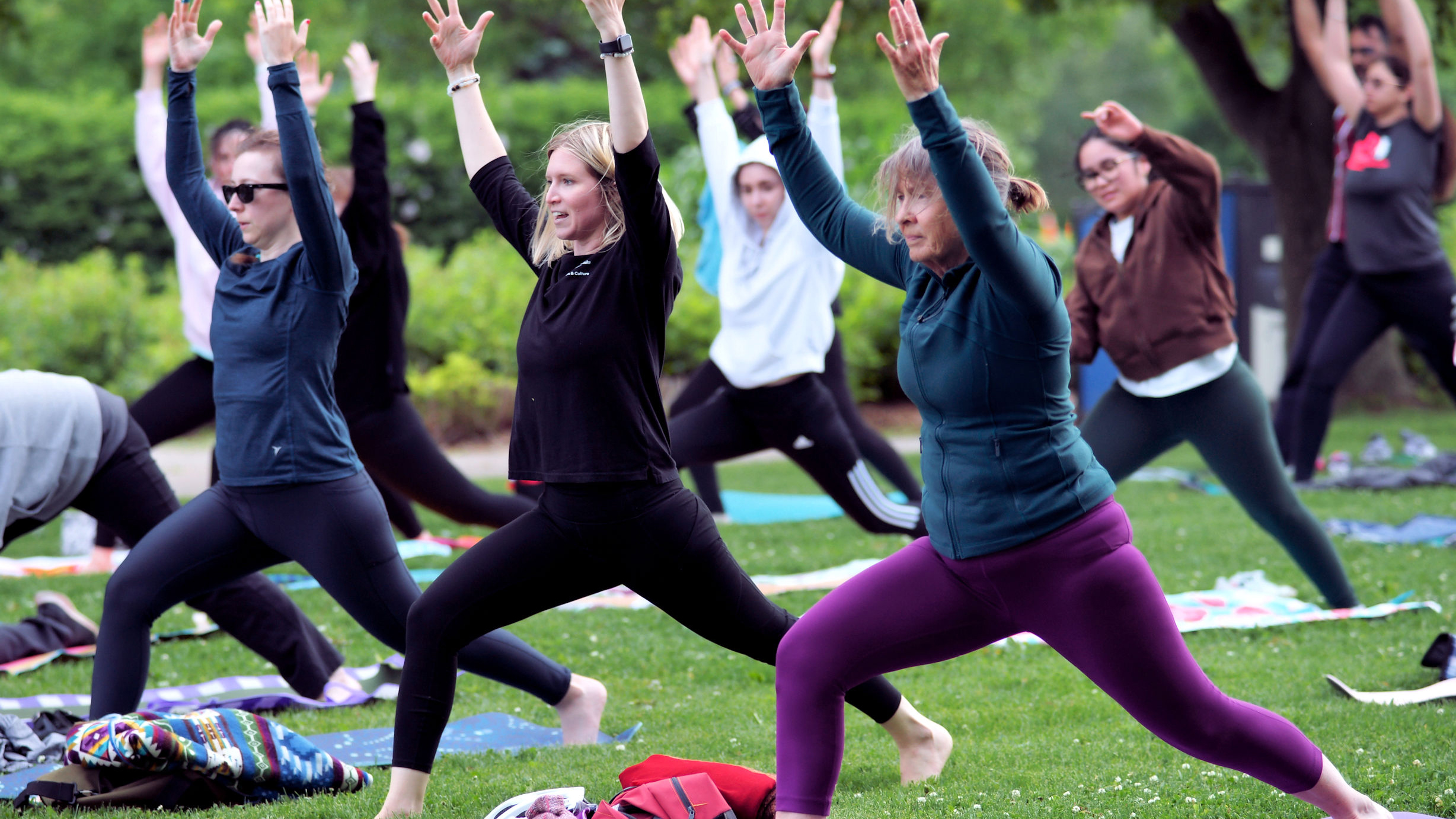 A group of people participate in Sunset Yoga at the Ajax waterfront.
