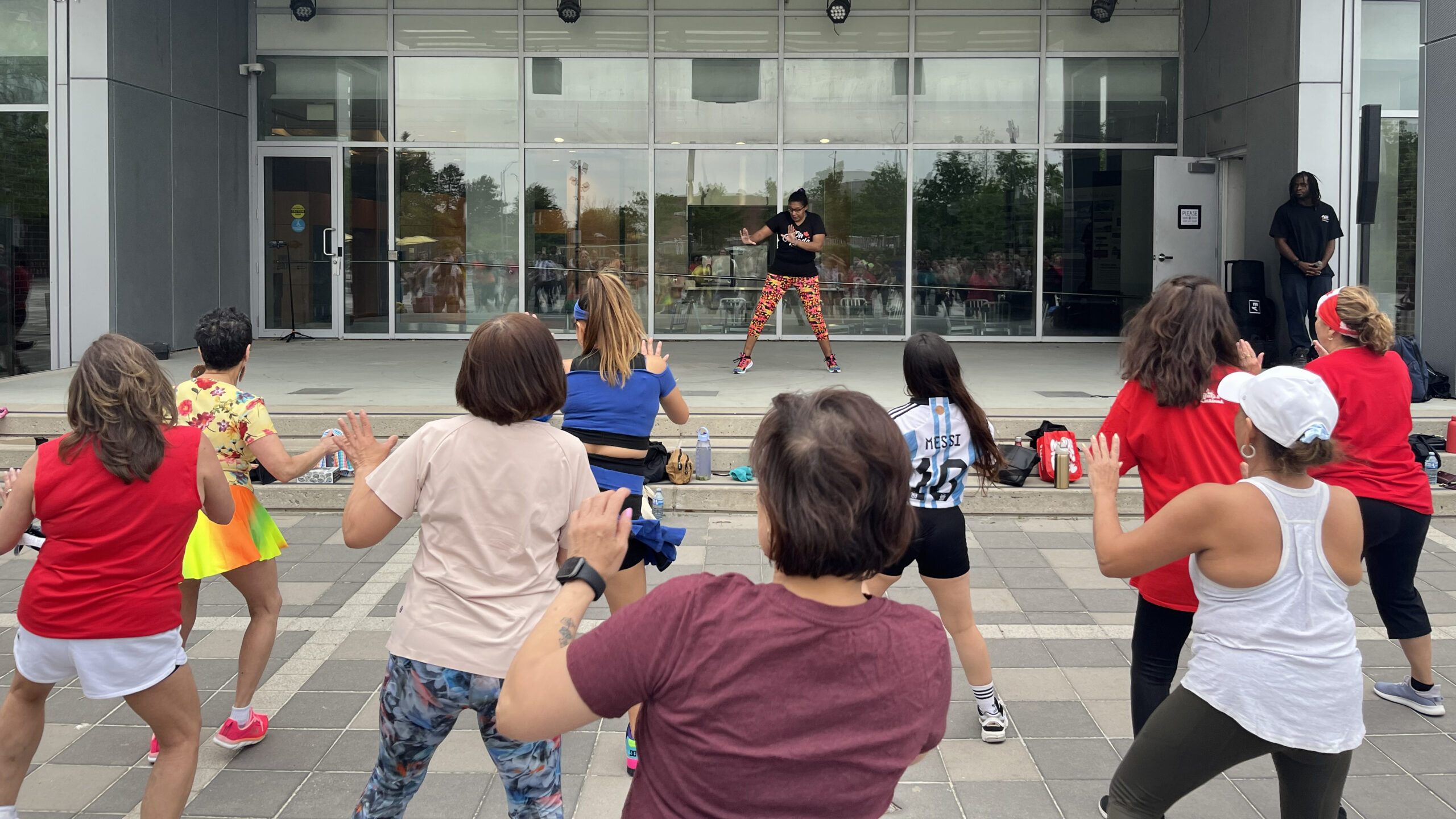 A fitness instructor leads participants at Zumba® in the Square at Pat Bayly Square.