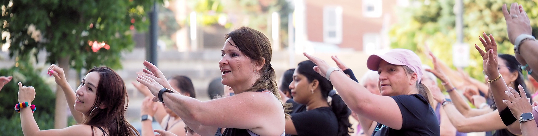 A group of people participate in Zumba® in the Square at Pat Bayly Square.