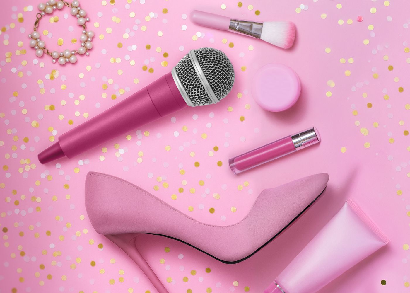 An illustration of a pink microphone, high heel, and make up, spread out on a pink backdrop