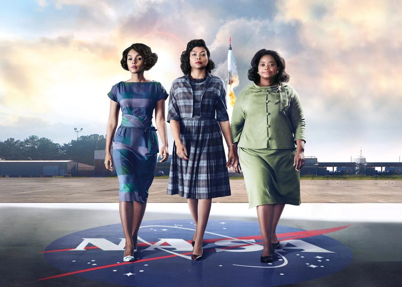 Three Africain American women walking together side by side on top of a NASA logo