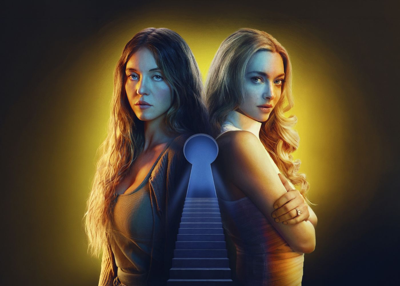 Two girls standing back-to-back. One has brown hair and the other has blonde.