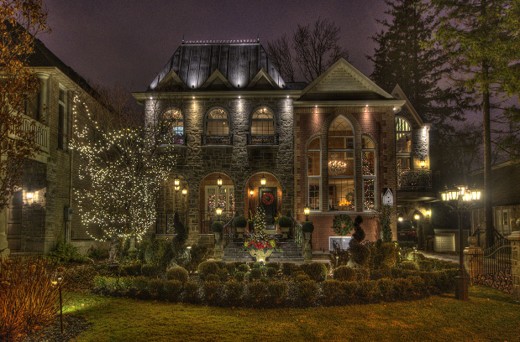 A heritage building is lit up with white lights at night.